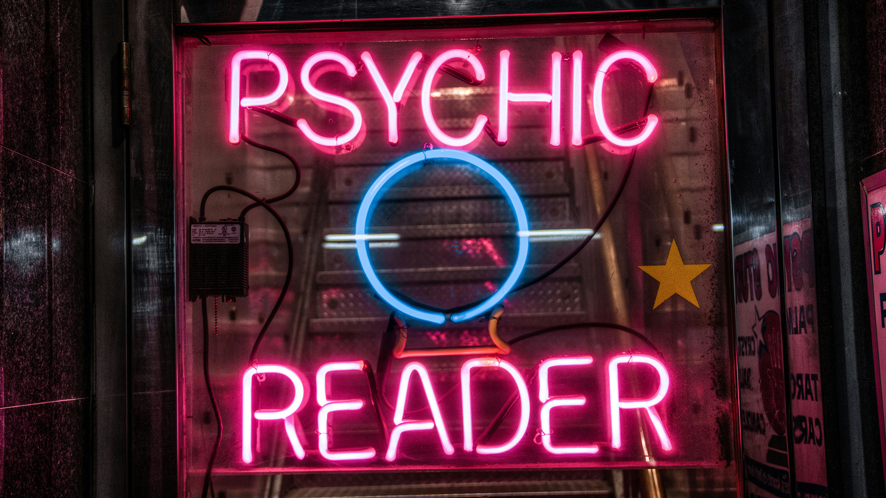 A neon sign that reads Psychic Reader