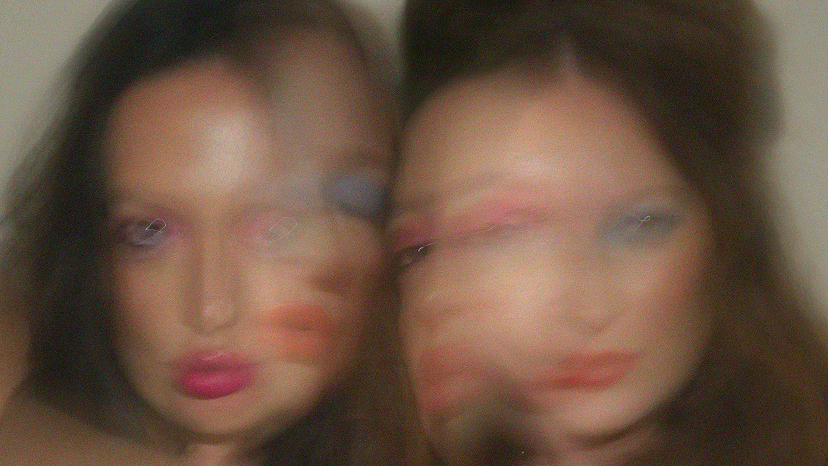 A layered image of two faces blurred 