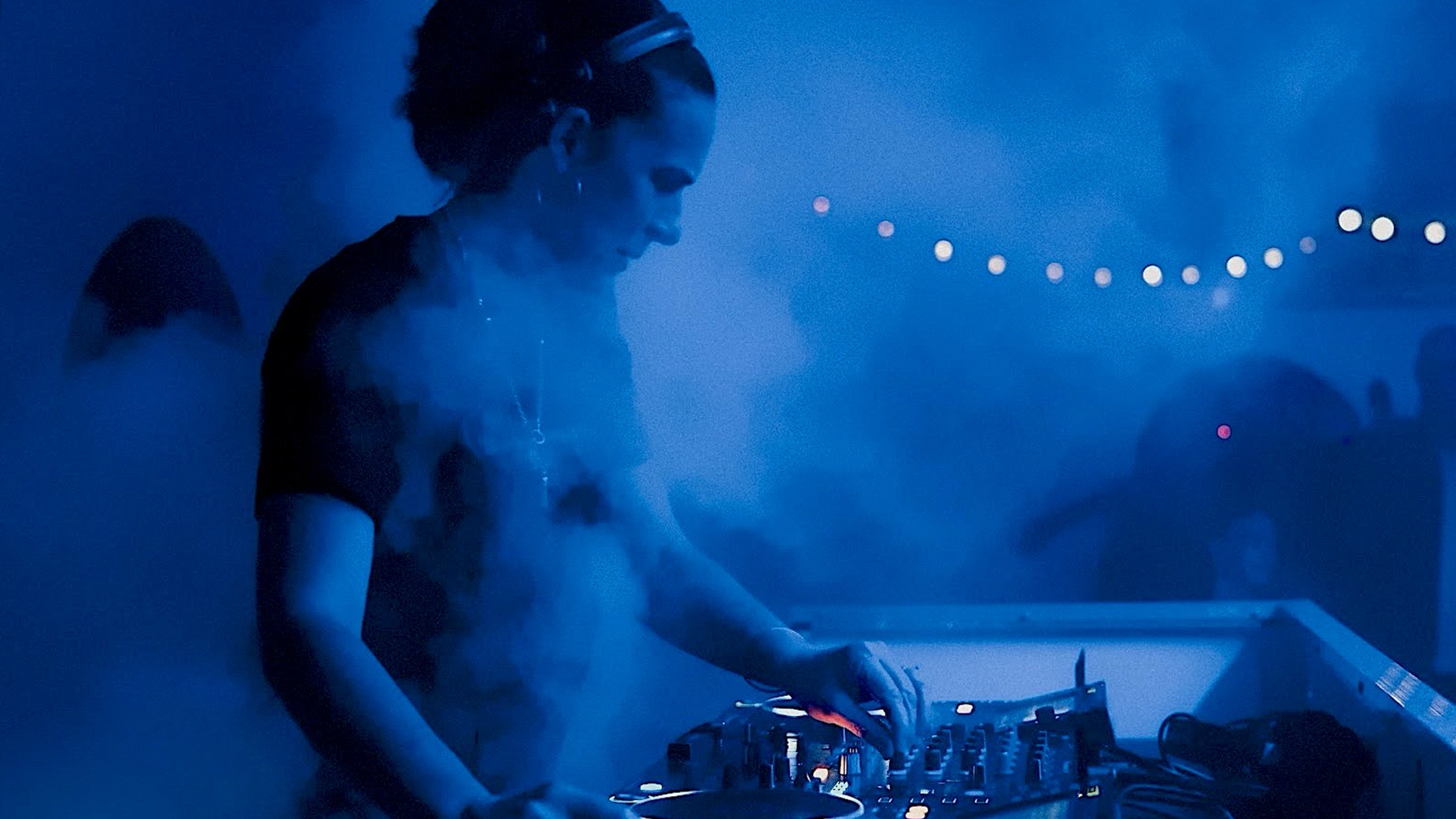 JNETT performing at an outdoor festival engulfed in smoke from a smoke machine